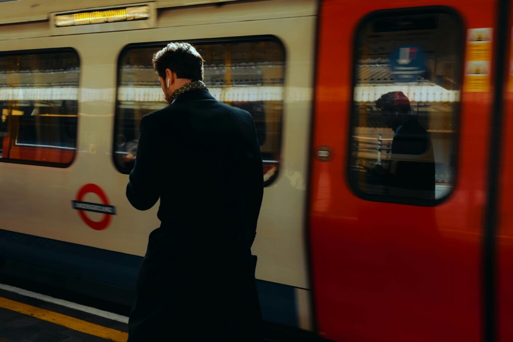 Man Walking along Running Subway Tray