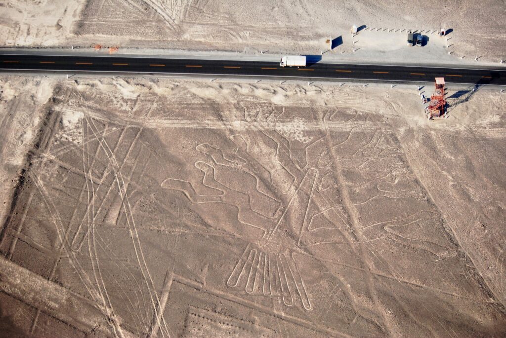 Aerial view showing the ancient Nazca Lines geoglyph in Peru's desert landscape.