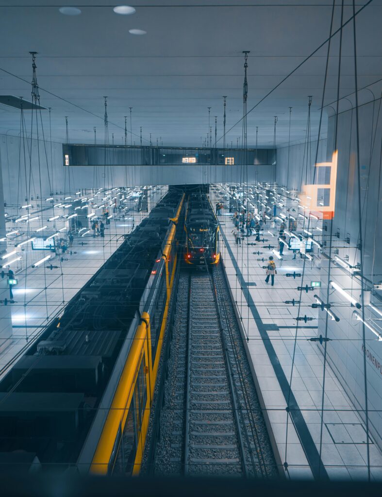 Aerial view of a sleek train station in Karlsruhe, Germany with yellow trains on parallel tracks.