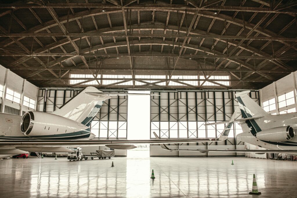 Private jets parked inside a large hangar in Paris, offering a glimpse into aviation luxury.