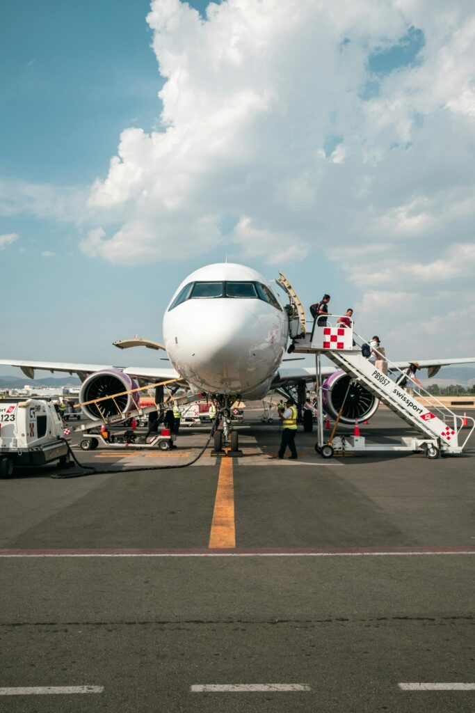 View of Passengers Walking Out of the Airplane at an Airport