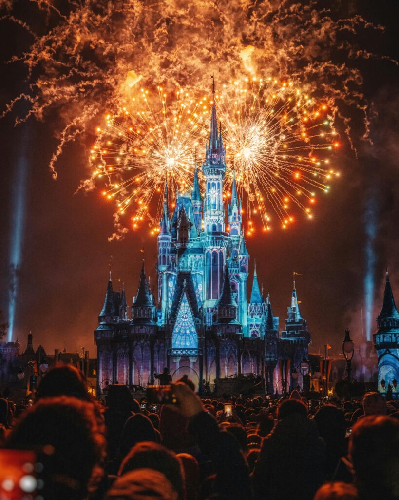 Enchanting fireworks illuminate the iconic castle at night, creating a magical celebration atmosphere.