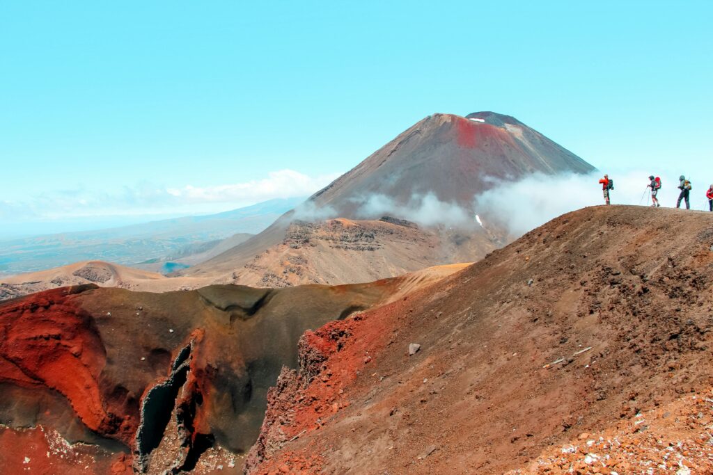 Adventurers hike near Mt. Ngauruhoe's stunning volcanic landscape in New Zealand.