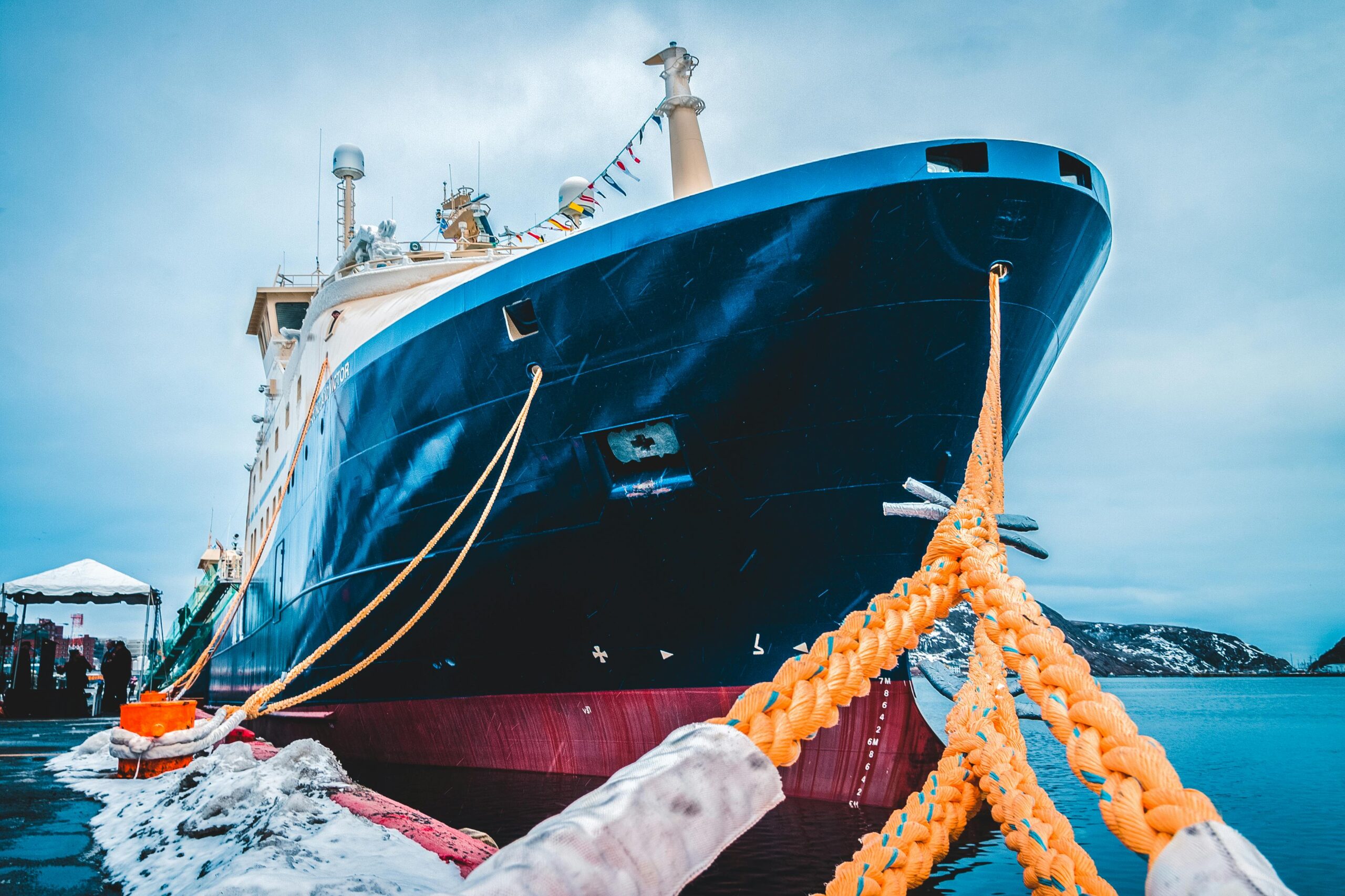 Majestic ship docked in winter harbor, showcasing nautical charm and adventure.