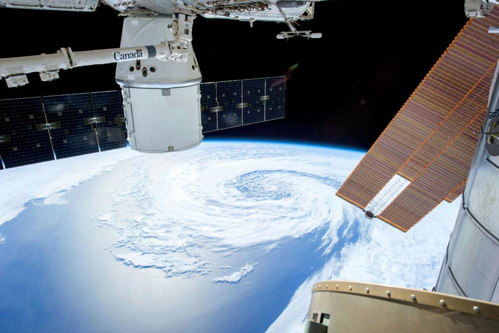 A mesmerizing view of Earth as seen from a space station with solar panels and satellite modules.