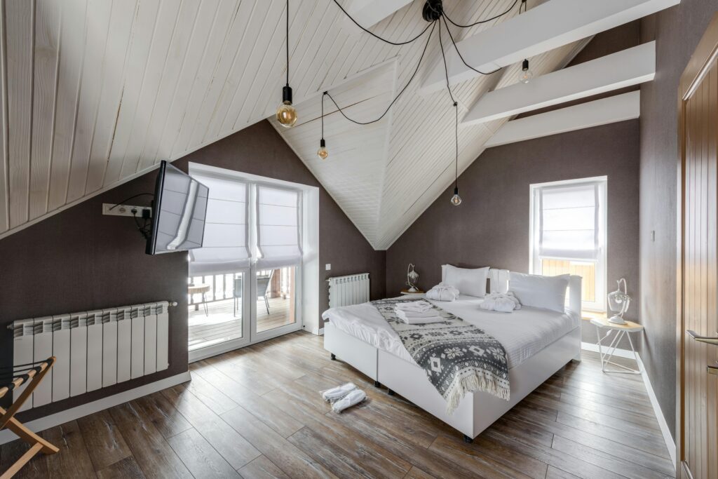 Stylish attic bedroom interior with modern furnishings and a cozy atmosphere.