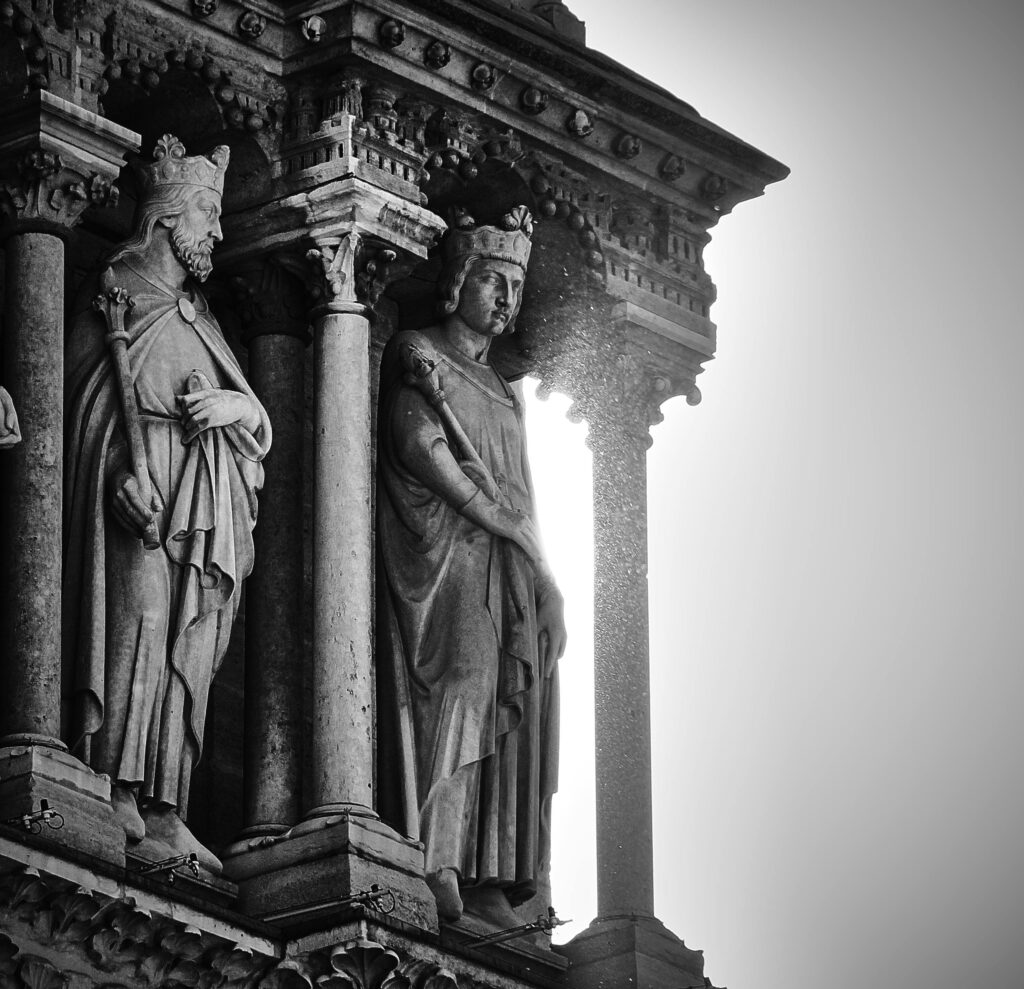 Captivating black and white close-up of gothic sculptures in Notre-Dame Cathedral, Paris.