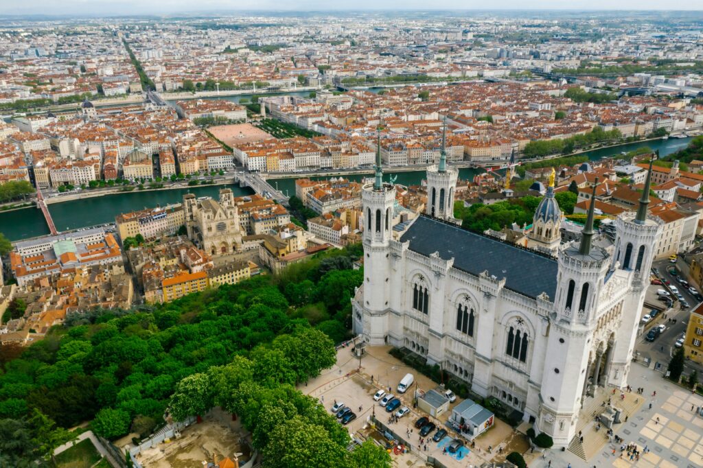 Stunning aerial view of Lyon featuring the Basilica of Notre-Dame de Fourvière and the cityscape.