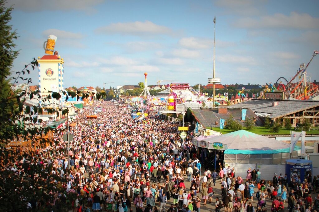 A lively scene at Oktoberfest in Munich with a massive crowd enjoying the festivities and attractions.