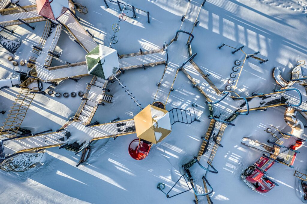 Explore the intricate design of a snowy playground from a high angle in winter, Red Wing, MN.