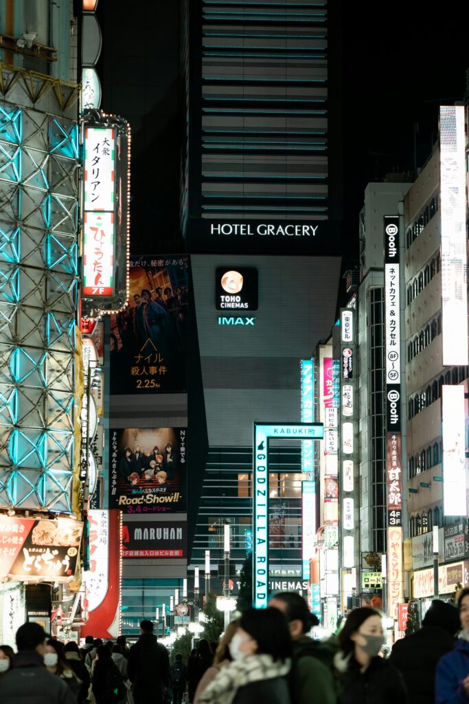 Explore the lively streets of Shinjuku, Tokyo, showcasing illuminated signages and a bustling nightlife.