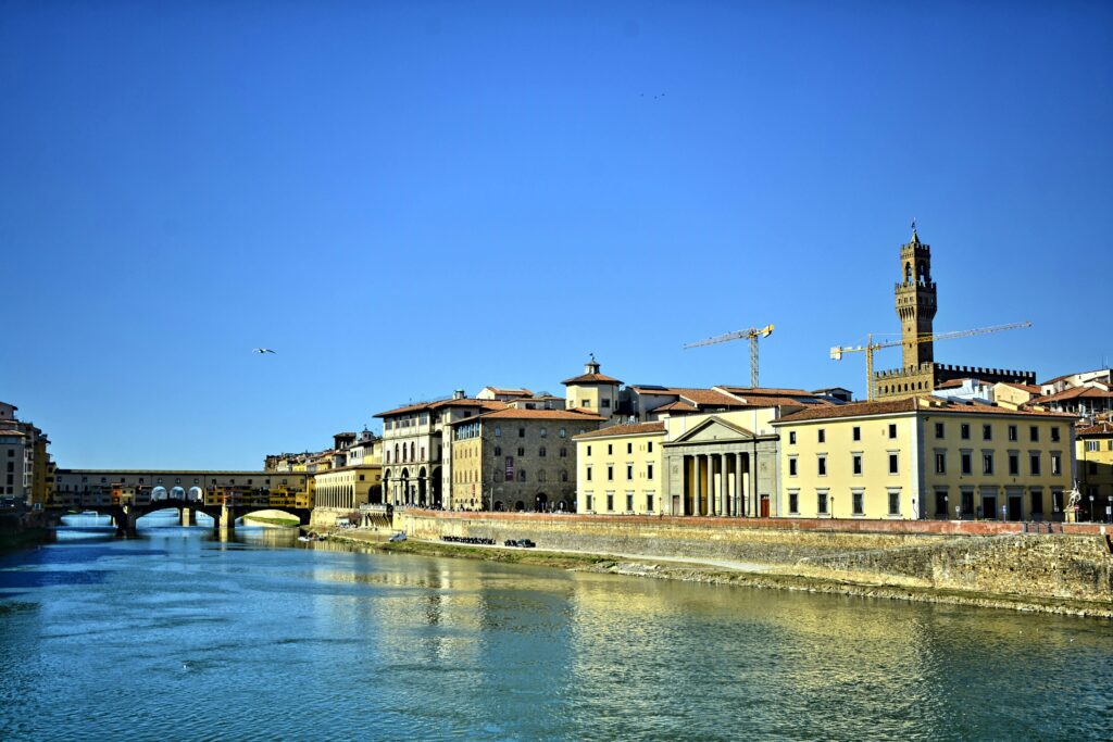 Scenic view of Ponte Vecchio in Florence under a clear blue sky.