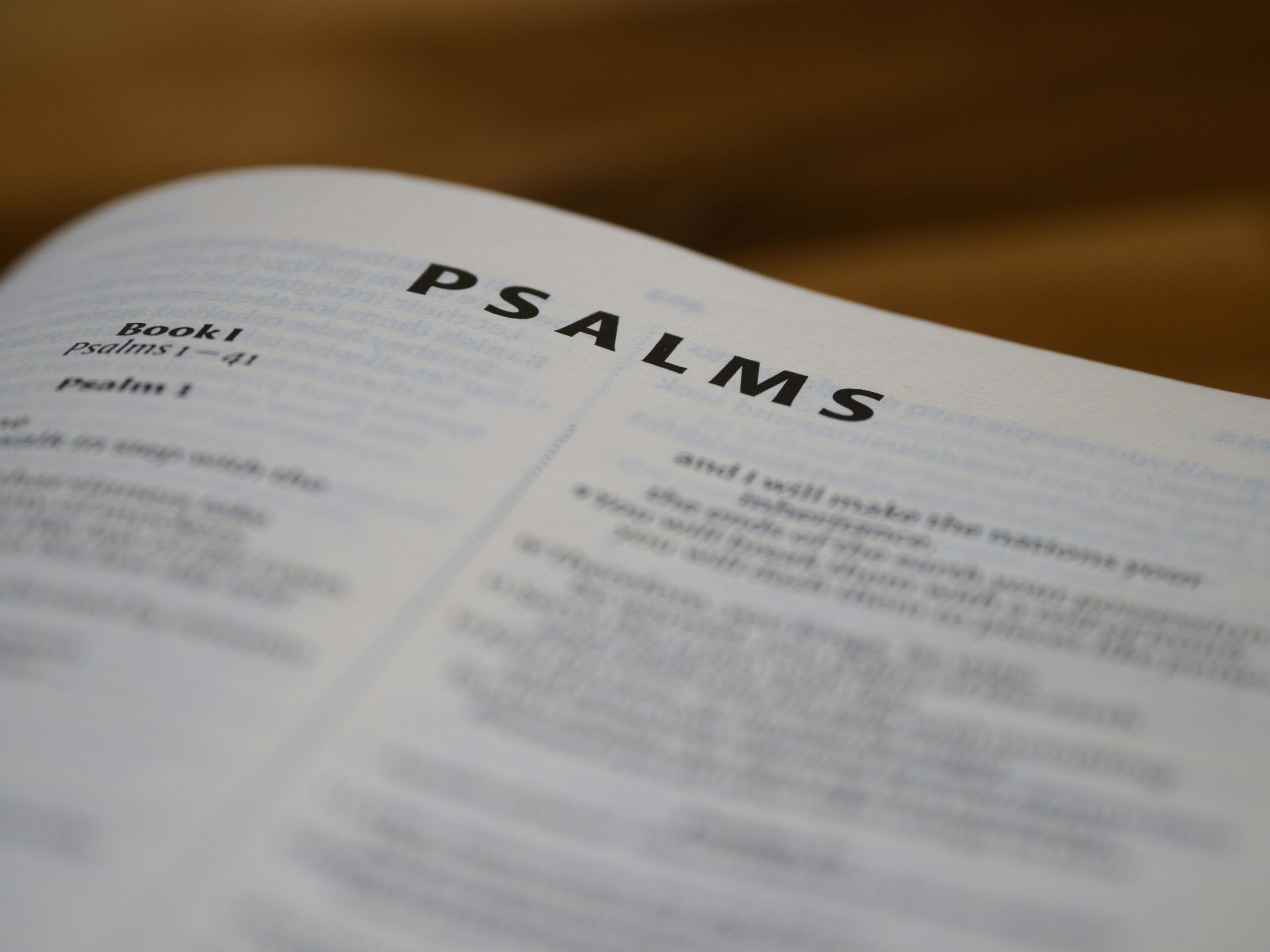 Close-up of open Bible showing the Psalms page with clear typography.