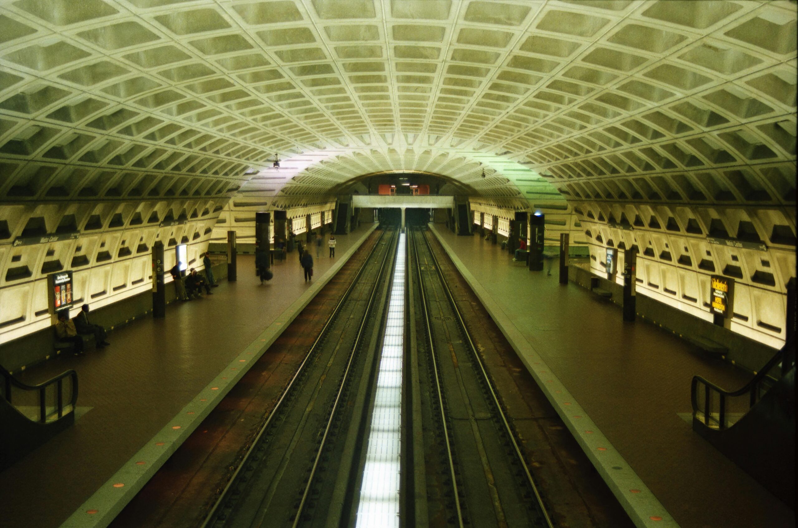 Spacious metro station with concrete arches and empty train tracks in Washington, DC.