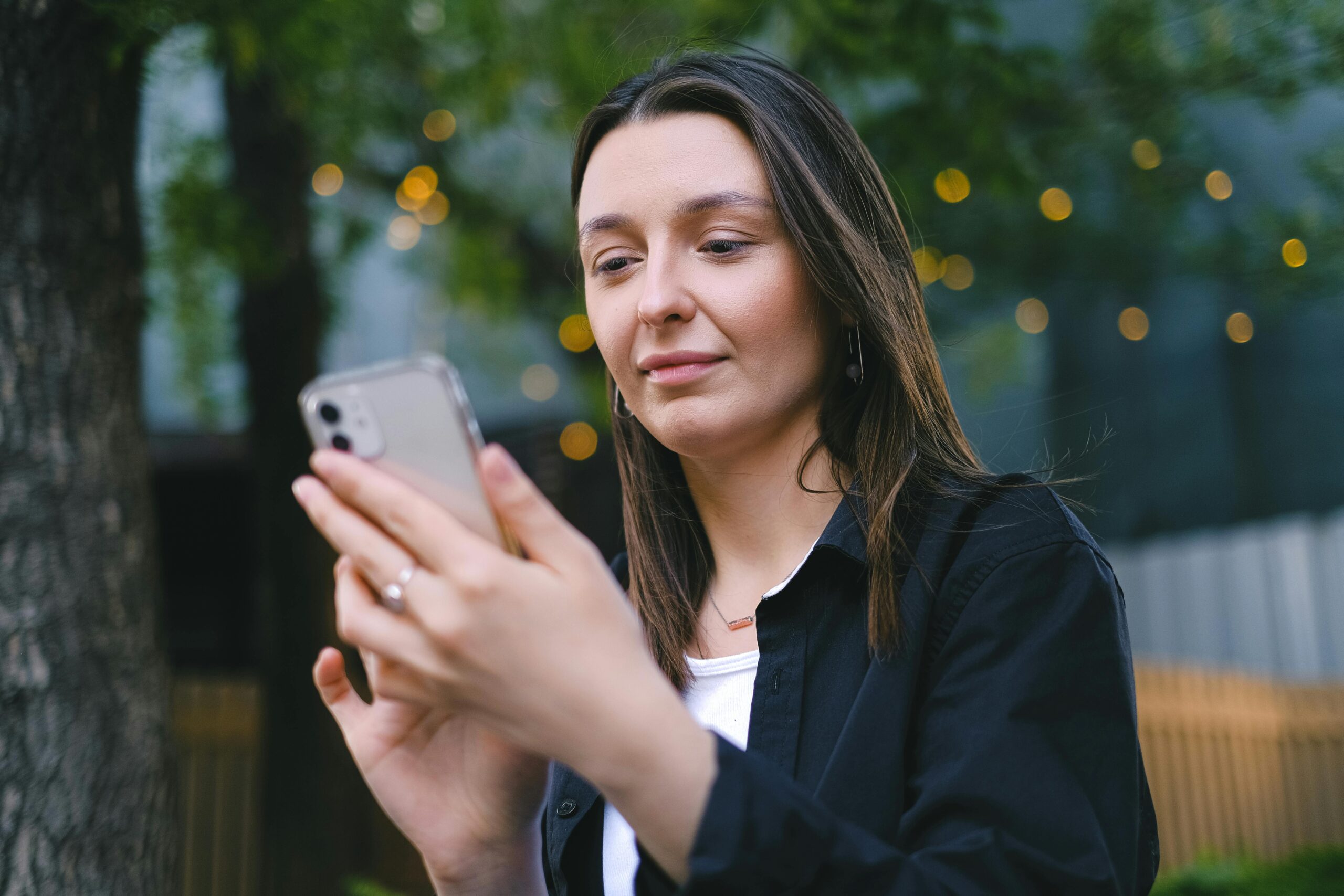 Woman in Black Blazer Holding Silver Iphone 6