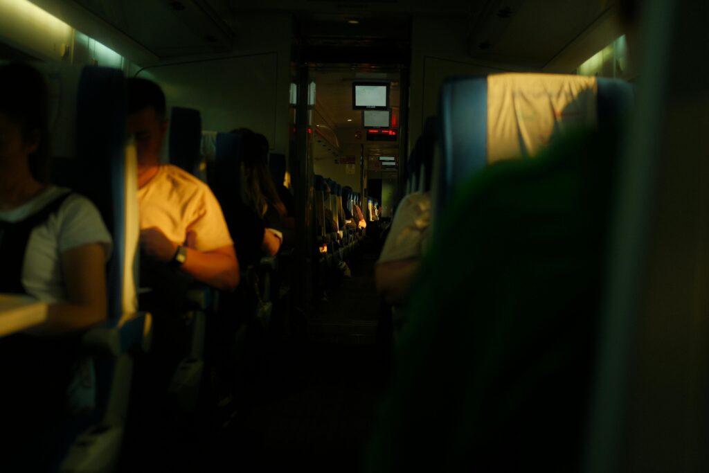 Cozy interior view of an airplane cabin with passengers relaxing during their flight.