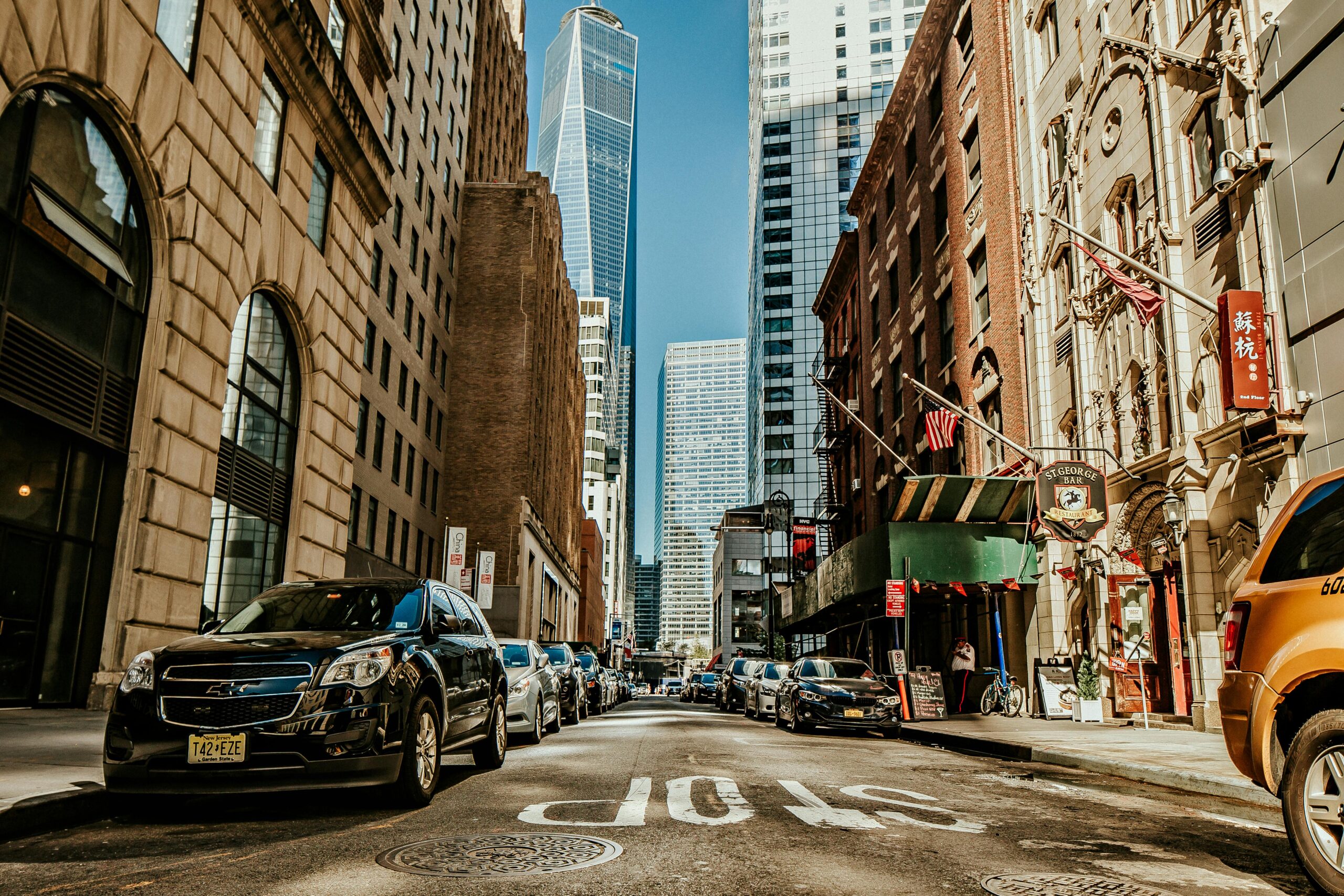 Dynamic street view of New York City with skyscrapers and urban life.