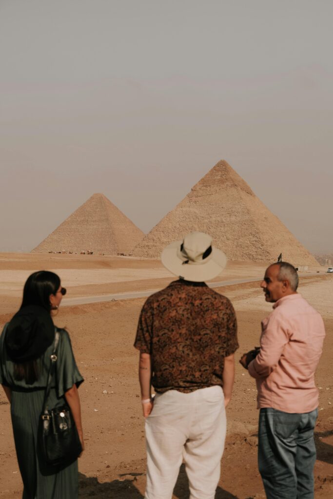 Tourists admire the iconic pyramids of Giza, experiencing history and culture.