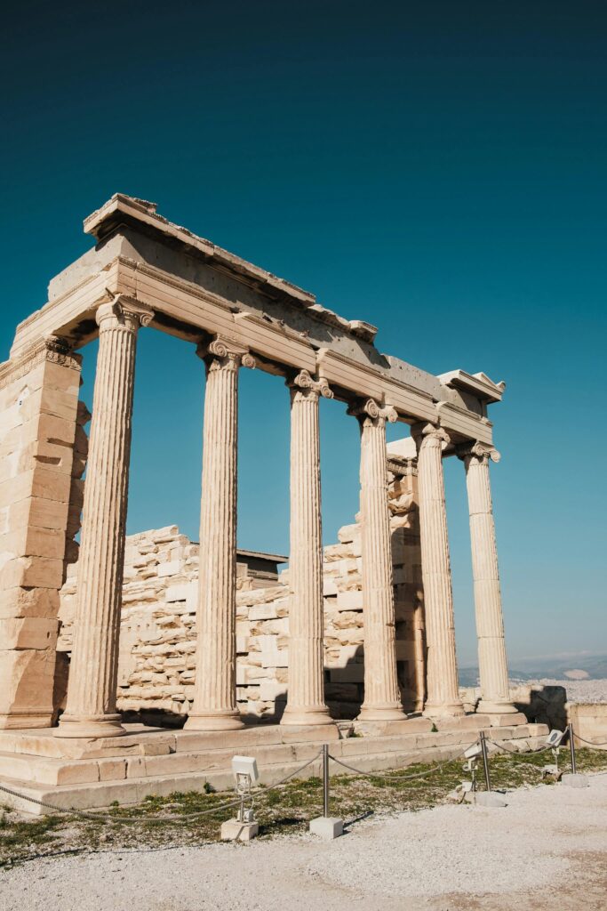 Iconic view of the ancient Greek temple ruins in Athens with clear blue skies.