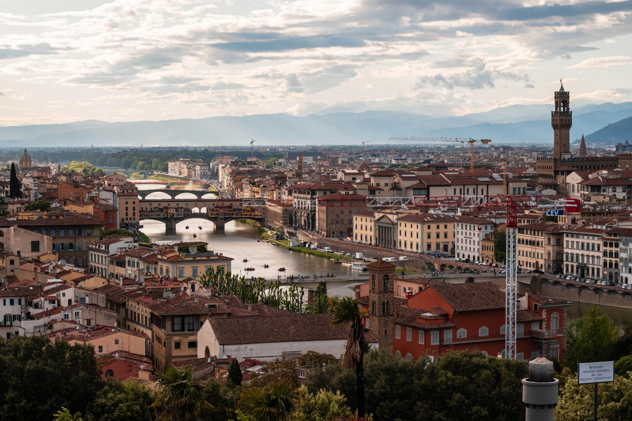 A breathtaking view of Florence, Italy featuring the iconic Ponte Vecchio and surrounding architecture.