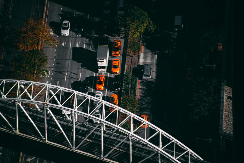 Aerial view capturing bustling NYC traffic beneath a prominent bridge.