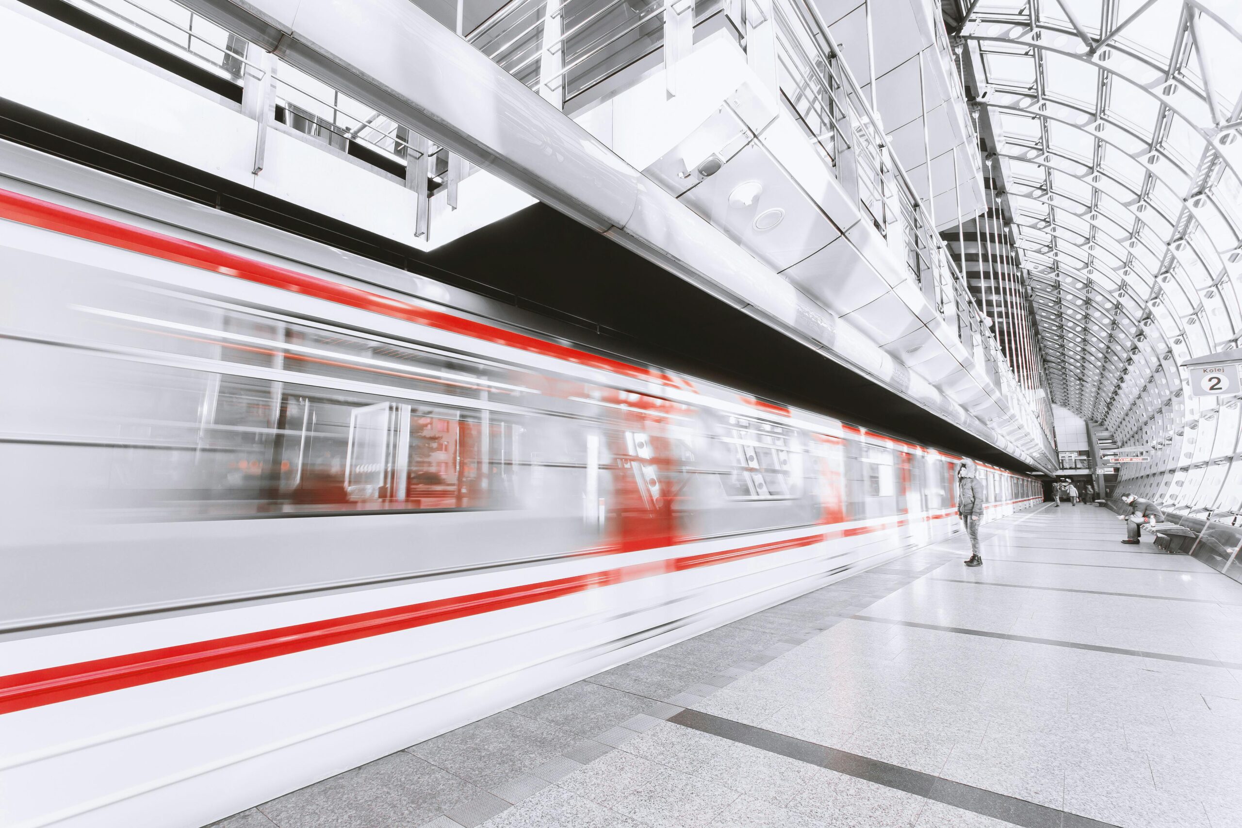 Blurred high-speed train in a sleek modern station, capturing urban commuting and motion.