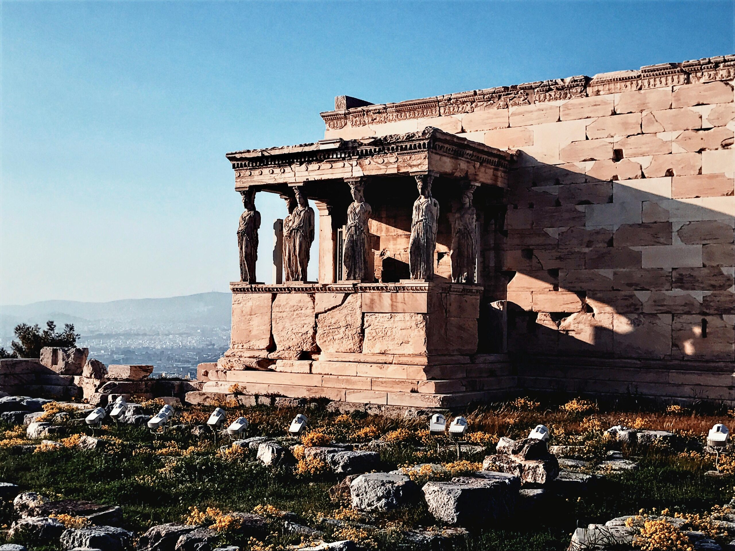 Photograph of the Caryatids on the Erechtheion, Acropolis, Athens, showcasing ancient Greek architecture.