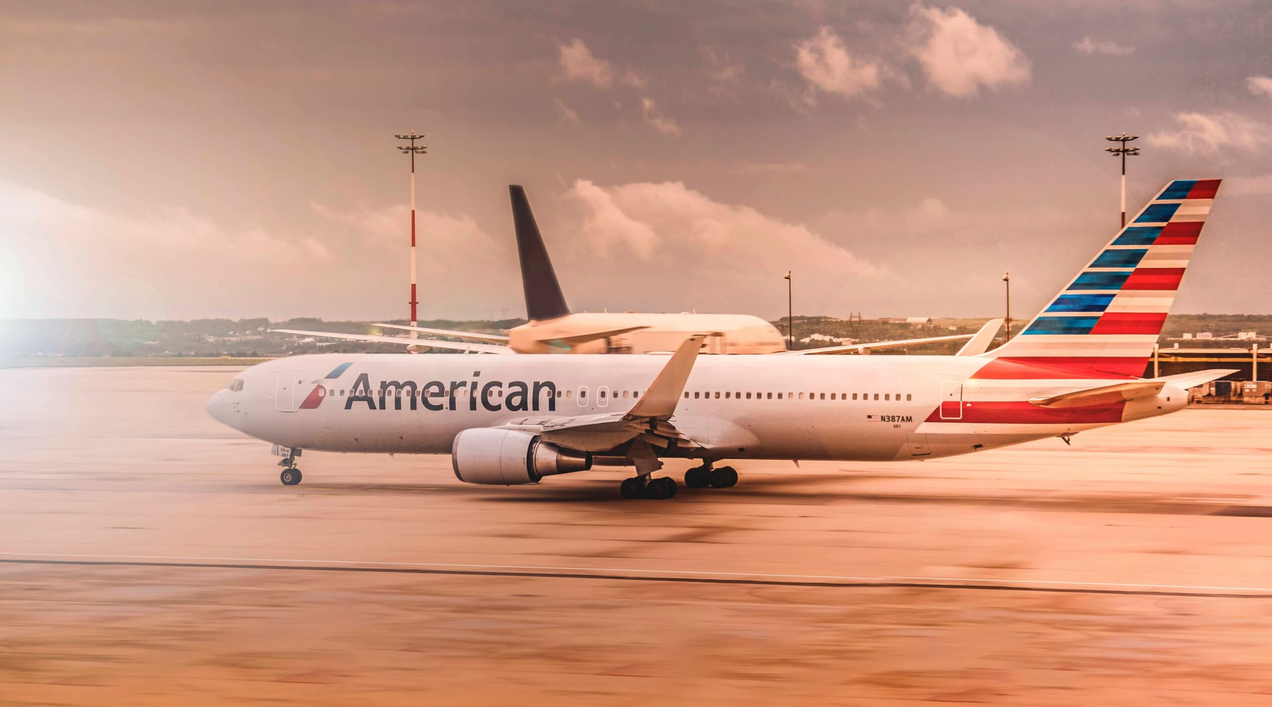 American Airlines aircraft on the runway at Paris Charles de Gaulle Airport during daylight.