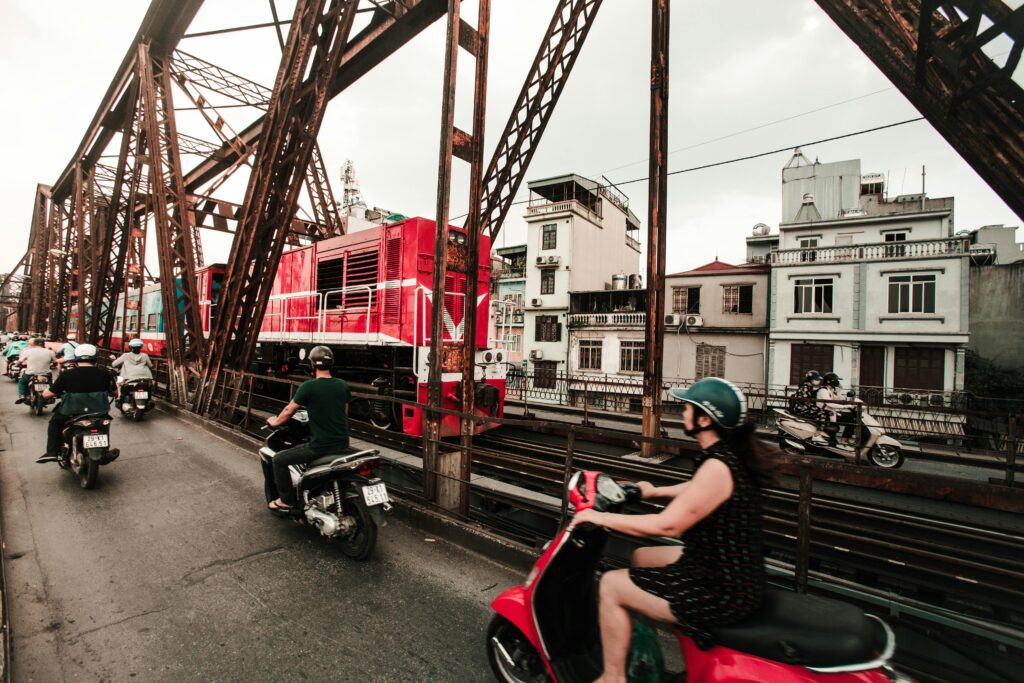 Dynamic view of traffic and train crossing a bridge in Hanoi, Vietnam.