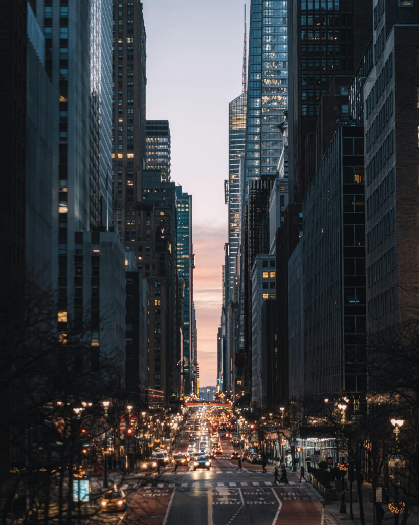 Dynamic urban city view with skyscrapers and bustling traffic at twilight, creating a modern city atmosphere.