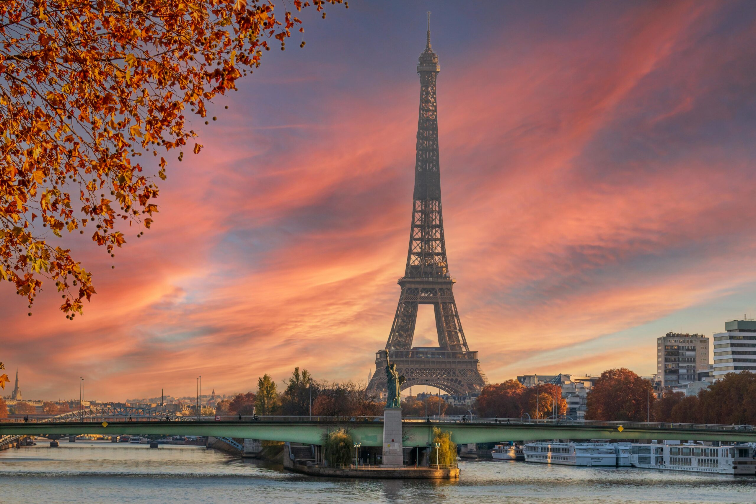 Stunning view of the Eiffel Tower during a colorful autumn sunset in Paris.