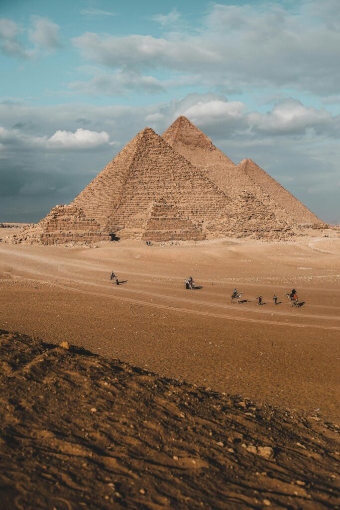 Stunning landscape of the Pyramids of Giza under a blue sky, capturing Egypt's ancient wonder.