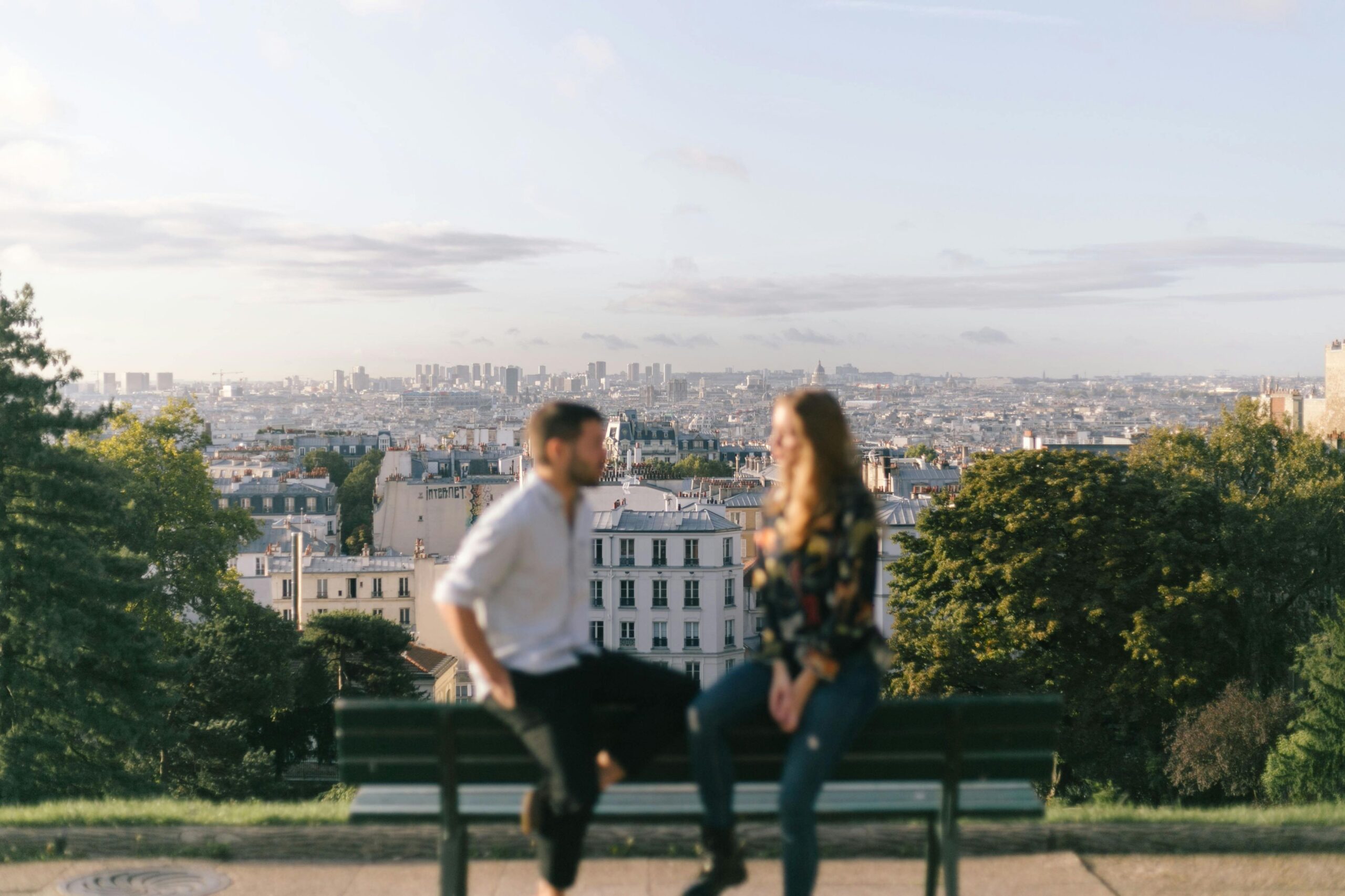 A couple enjoying a romantic moment with a beautiful view of Paris cityscape.