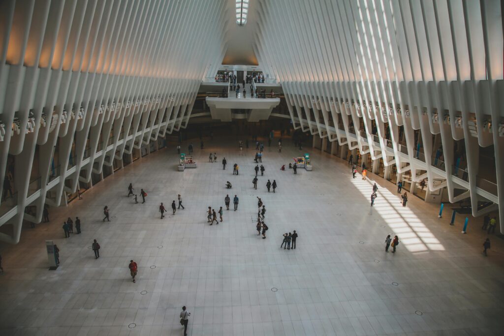 Spacious interior of a modern transit hub showcasing sleek architectural design with minimalistic elements.