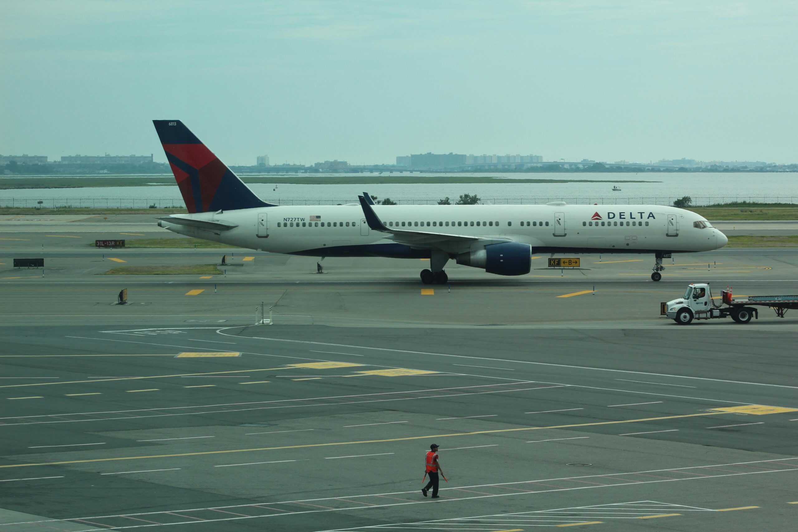 A Delta Air Lines plane positioned on an airport runway ready for departure.