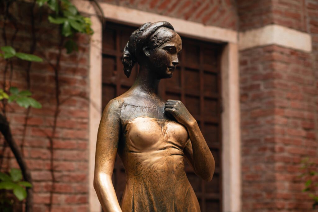 Bronze statue of Juliet at Casa di Giulietta in Verona, Italy, iconic landmark.