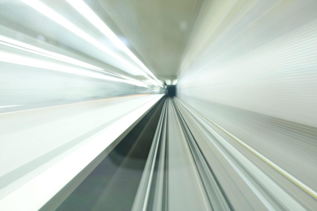 Abstract motion blur inside a modern, illuminated subway tunnel in Nuremberg, Germany. Long exposure shot.