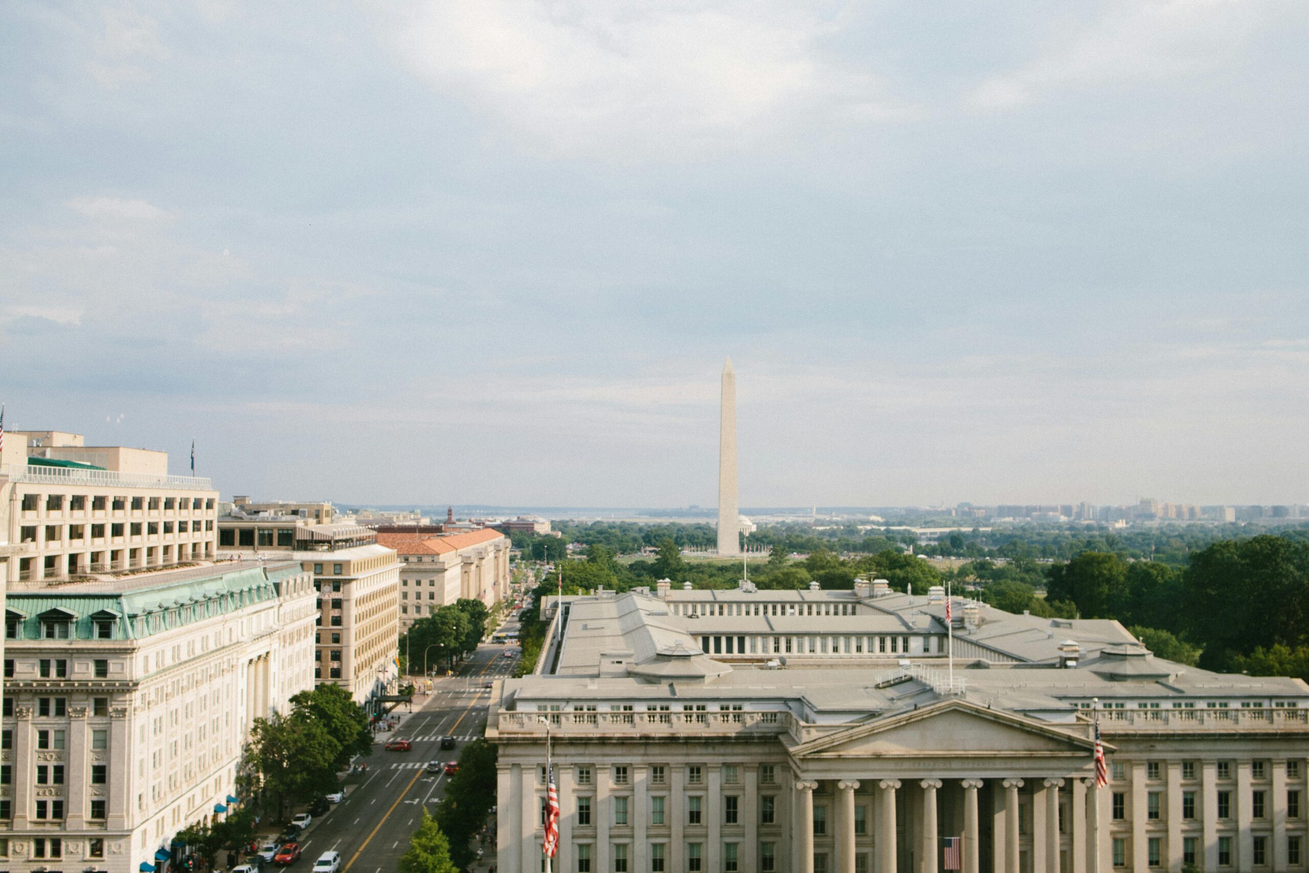 Breathtaking aerial view of the Washington Monument and surrounding architecture on a sunny day in Washington, D.C.