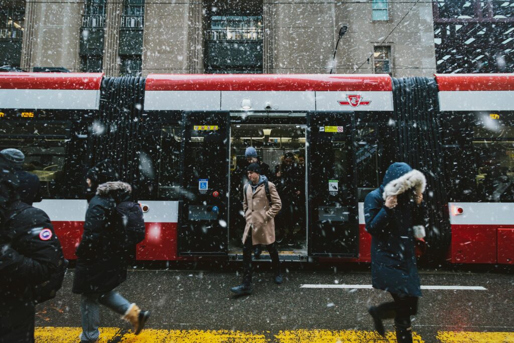 Commuters navigate a snowstorm outside a TTC streetcar in downtown Toronto.