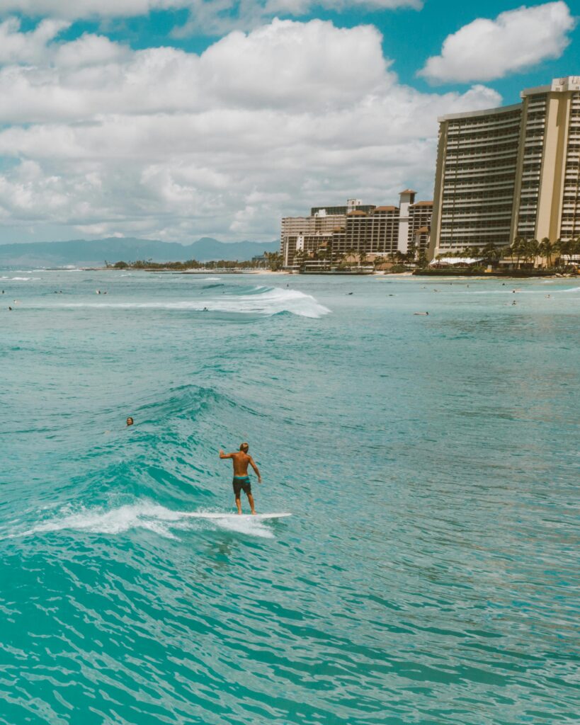 Exciting surf scene with a surfer skillfully riding waves at Waikiki Beach, Hawaii.