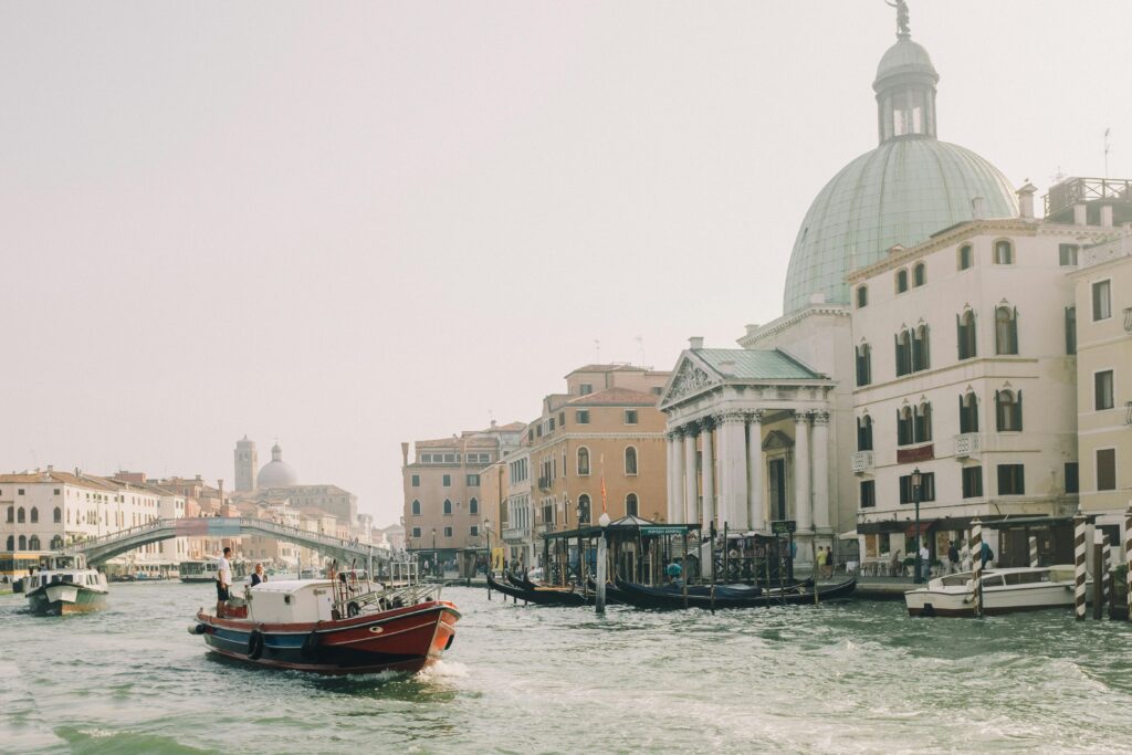 Experience the serene beauty of a boat ride along Venice's iconic Grand Canal.