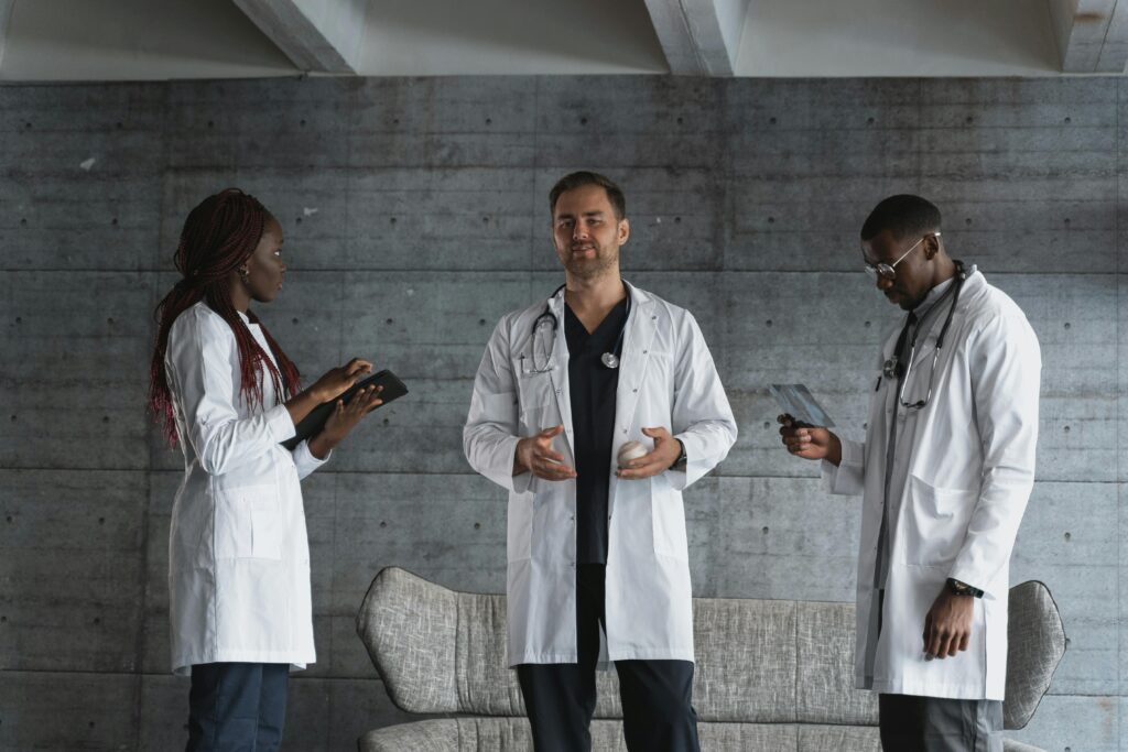 A group of multiethnic doctors discussing medical cases indoors.