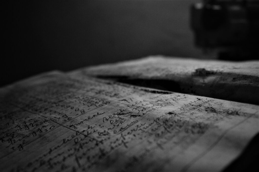 Close-up of an aged handwritten journal with focus on ink and texture.