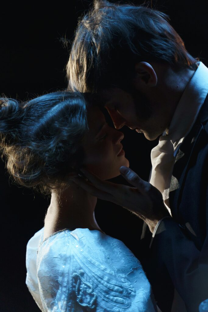 Intimate theatrical moment showcasing romance and drama between two performers on stage.