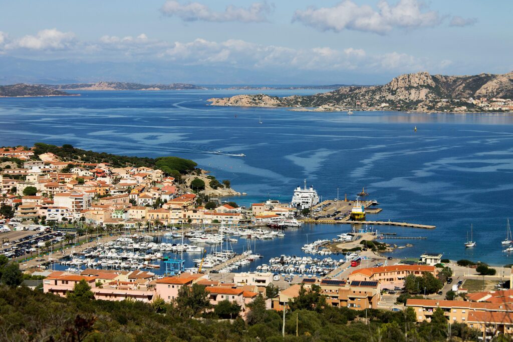 Scenic aerial shot of Palau harbor and town in Sardinia, showcasing vibrant coastal life.