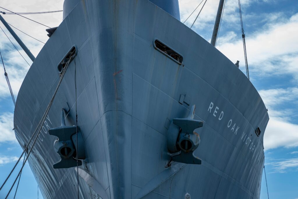 A close-up view of the Red Oak Victory ship's bow, highlighting its distinct navy design.