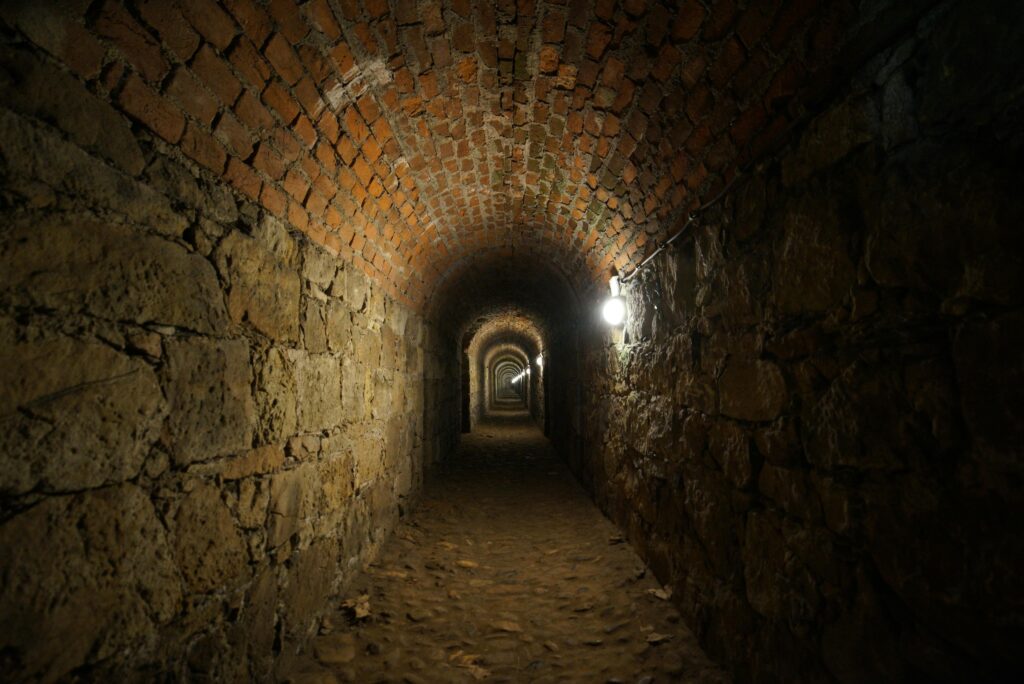 Explore the mysterious antique brick tunnel in Kłodzko, Poland, with its captivating architecture.