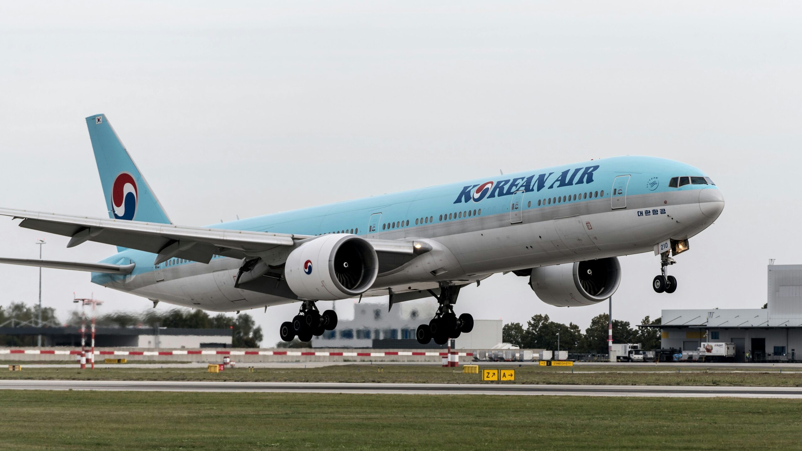 A Korean Air aircraft lands at Prague airport, showcasing aviation dynamics.