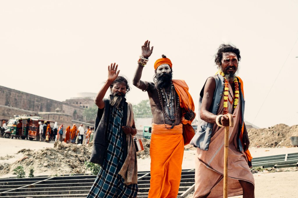 A vibrant portrait of Sadhu holy men in traditional attire at a street festival in Prayagraj, India.