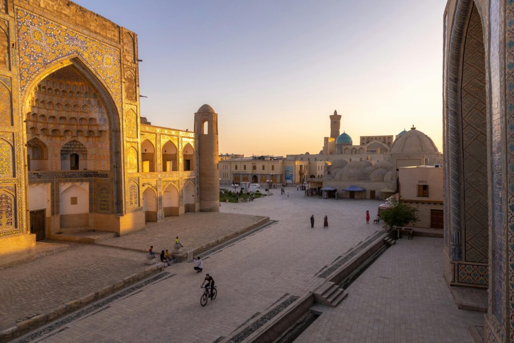 Scenic view of Khiva's historic architecture under sunset skies, Uzbekistan.